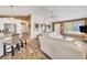 Inviting living room featuring wood floors, a comfortable sofa, and an open layout to the kitchen and dining area at 123 Hammock Rd, Anna Maria, FL 34216