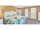Inviting main bedroom featuring a tropical design, ensuite bathroom, and ample closet space at 123 Hammock Rd, Anna Maria, FL 34216