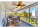 This is an expansive screened patio featuring ceiling fans, outdoor seating and lush tropical views at 123 Hammock Rd, Anna Maria, FL 34216