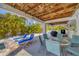 Covered patio area with outdoor dining and BBQ area, great for entertaining by the pool at 123 Hammock Rd, Anna Maria, FL 34216