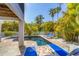 Relaxing pool with sun loungers is nestled amongst mature tropical landscaping, offering a serene retreat at 123 Hammock Rd, Anna Maria, FL 34216