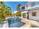 Relaxing pool area features a brick paver patio with comfortable seating for outdoor enjoyment at 123 Hammock Rd, Anna Maria, FL 34216