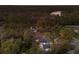 Wide aerial shot displaying a beautiful home surrounded by dense trees and a calm pond at 13608 11Th E Ter, Bradenton, FL 34212