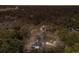 Expansive aerial view showcasing the home nestled amongst lush trees and a serene pond at 13608 11Th E Ter, Bradenton, FL 34212
