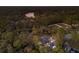 A high angle view of a charming home near a beautiful pond, all enveloped by mature trees at 13608 11Th E Ter, Bradenton, FL 34212