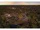 Serene aerial image captures the home nestled in a vibrant, wooded neighborhood near a pond at 13608 11Th E Ter, Bradenton, FL 34212