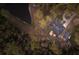 Birds-eye view of a home next to a tranquil pond surrounded by a canopy of trees at 13608 11Th E Ter, Bradenton, FL 34212
