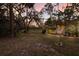 Expansive backyard featuring mature trees and landscaping, perfect for outdoor activities and relaxation at 13608 11Th E Ter, Bradenton, FL 34212
