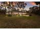 Expansive backyard view of the home featuring a covered patio, screened porch, and lush lawn at 13608 11Th E Ter, Bradenton, FL 34212