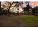 Sprawling backyard with mature trees and seating area, offering a serene outdoor space at 13608 11Th E Ter, Bradenton, FL 34212