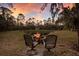 Backyard fire pit with seating, perfect for relaxing and enjoying outdoor evenings at 13608 11Th E Ter, Bradenton, FL 34212
