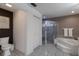 Bathroom featuring tile floor, bathtub, shower with glass door, and white vanity at 13608 11Th E Ter, Bradenton, FL 34212