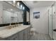 Bathroom featuring a modern vanity, decorative lighting, glass shower, and patterned tile flooring at 13608 11Th E Ter, Bradenton, FL 34212