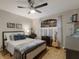 Cozy bedroom with neutral walls, ceiling fan, and bright natural light from a window at 13608 11Th E Ter, Bradenton, FL 34212
