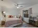 Bedroom with a pink comforter, ceiling fan, vanity, and natural light at 13608 11Th E Ter, Bradenton, FL 34212