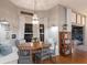 Charming dining area with chandelier lighting, bench seating, and outdoor views at 13608 11Th E Ter, Bradenton, FL 34212