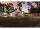 View of the back of the house with an exterior staircase and fenced backyard at 13608 11Th E Ter, Bradenton, FL 34212