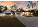 Charming home with a three-car garage and a separate garage or storage area, nestled among mature trees at 13608 11Th E Ter, Bradenton, FL 34212