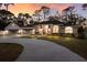 Inviting home with a circular drive, manicured landscaping, and a three-car garage at sunset at 13608 11Th E Ter, Bradenton, FL 34212