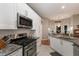 Well-equipped kitchen with stainless steel appliances and adjacent dining area at 13608 11Th E Ter, Bradenton, FL 34212