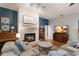 Cozy living room with stone fireplace, modern sofa, and decorative accents at 13608 11Th E Ter, Bradenton, FL 34212
