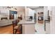 Open-concept space connecting the kitchen and living room, with a breakfast bar and modern appliances at 13608 11Th E Ter, Bradenton, FL 34212