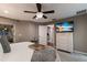 Primary bedroom featuring a ceiling fan, TV above the dresser, and entry to en suite bath at 13608 11Th E Ter, Bradenton, FL 34212