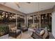 Inviting screened patio featuring comfortable seating, swing, and views of the lush backyard at 13608 11Th E Ter, Bradenton, FL 34212