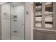 Modern bathroom shower with glass doors, subway tile, and built in shelving at 13608 11Th E Ter, Bradenton, FL 34212