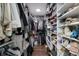 Walk-in closet with custom storage solutions, shelving, and shoe racks at 13608 11Th E Ter, Bradenton, FL 34212