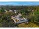 Aerial view of a house with a fenced yard surrounded by mature trees in a residential area at 1397 43Rd St, Sarasota, FL 34234