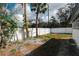 Spacious backyard with a white wooden fence, offering privacy and room for outdoor activities at 1397 43Rd St, Sarasota, FL 34234
