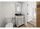 Bright bathroom featuring a decorative vanity with a black countertop and a classic medicine cabinet at 1397 43Rd St, Sarasota, FL 34234