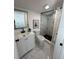 Modern bathroom featuring a stylish vanity, mirror, toilet, and a walk-in shower with marble-style tiles at 1397 43Rd St, Sarasota, FL 34234