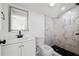 Modern bathroom features a stylish vanity, mirror, toilet, and a walk-in shower with marble-style tile at 1397 43Rd St, Sarasota, FL 34234