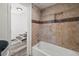 Bathroom with classic tilework in shower, plus tub and natural light at 1397 43Rd St, Sarasota, FL 34234
