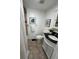 Cozy bathroom with decorative black and white artwork and dark accents at 1397 43Rd St, Sarasota, FL 34234