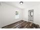 Bright bedroom features modern wood floors and natural light from the window overlooking the backyard at 1397 43Rd St, Sarasota, FL 34234