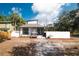 Charming home with white and black trim, complemented by well-placed shrubbery and a manicured front yard at 1397 43Rd St, Sarasota, FL 34234