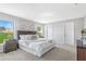 Cozy main bedroom featuring plush carpeting, soft lighting, and large windows offering natural light at 15110 Keene Ave, Port Charlotte, FL 33953