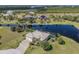 Aerial view of waterfront home showcasing the property's lush landscaping and serene water views at 16211 Cayman Ln, Punta Gorda, FL 33955