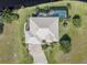Aerial view of the home showcasing the roof, driveway, landscaping and waterfront views at 16211 Cayman Ln, Punta Gorda, FL 33955