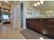 This powder room includes wood cabinets with granite countertop and access to the bedroom at 16211 Cayman Ln, Punta Gorda, FL 33955