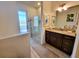 Bright bathroom featuring a granite countertop, wooden cabinets, and a glass enclosed shower with door to the backyard at 16211 Cayman Ln, Punta Gorda, FL 33955