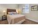 This bedroom offers a large window with shutter blinds and a comfortable queen-size bed at 16211 Cayman Ln, Punta Gorda, FL 33955