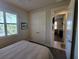 This bedroom features a window with shutter blinds and an attached bathroom at 16211 Cayman Ln, Punta Gorda, FL 33955