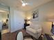 This bedroom provides additional seating, a ceiling fan, an art piece, and a door leading to another bedroom at 16211 Cayman Ln, Punta Gorda, FL 33955