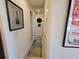 Hallway is decorated with wall art and provides access to other rooms in the home at 16211 Cayman Ln, Punta Gorda, FL 33955