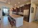 Modern kitchen with stainless steel appliances, granite countertops, and a large island with seating at 16211 Cayman Ln, Punta Gorda, FL 33955
