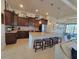Open kitchen with granite countertops, stainless appliances, large island with seating, and adjacent dining area at 16211 Cayman Ln, Punta Gorda, FL 33955